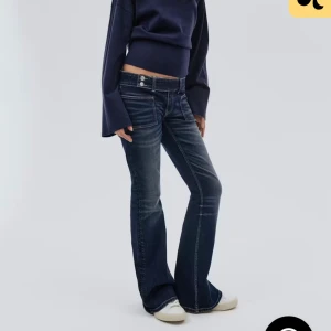  bootcut jeans  - Snygga mörkblå jeans med bootcut passform och låg midja. Jeansen har klassiska fickor, kontrastsömmar och är tillverkade i ett slitstarkt denimtyg. Perfekta för dig som gillar en retro vibe och vill ha ett par jeans som sticker ut.