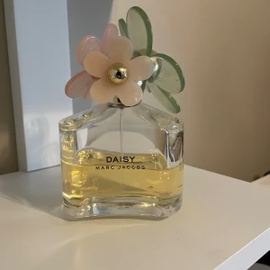 Två Marc Jacobs parfymer - Snygga flaskor från Marc Jacobs: Daisy med blommig kork och Perfect med unik dekoration. Perfekt för dig som vill ha något trendigt och lekfullt på hyllan.