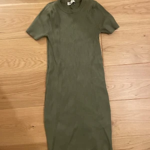 Olivgrön ribbad klänning från Zara - Priset går att buda på🥰 olivgrön ribbad klänning från Zara i storlek S. Klänningen har korta ärmar, rund hals och är figurnära med en enkel, stilren design. Materialet är mjukt och stretchigt.