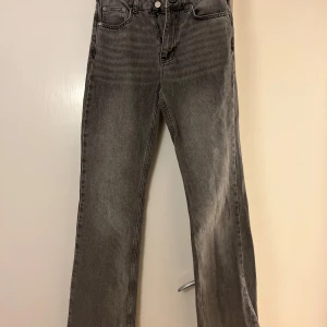 Gråa straight/utsvängda jeans från Perfect Jeans - Säljer ett par gråa jeans från Perfect Jeans i rak modell men dom är lite utsvängda . Jeansen har klassisk femficksdesign, normalhög midja och stängs med dragkedja och knapp. Jeansen är väl använda men utan skavanker 