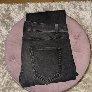 Svarta straight fit jeans från Next - Säljer ett par svarta jeans från Next Denim Goods Co i straight fit-modell. Jeansen har klassisk femficksdesign, bälteshällor och knappstängning. Materialet är mjukt denim och färgen är tvättad svart med lätt slitning för en cool look.