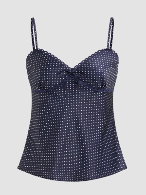 Mörkblå prickig satinlinnetopp - Trendigt linne i mörkblå satin med vita prickar, tunna justerbara axelband och söt rosettdetalj framtill. Toppen har en lätt utsvängd passform och dekorativ kant vid bysten. XS men passar även S