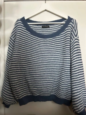 Randig blåvit stickad tröja - Säljer en chill stickad tröja från Shein. Den har blå och vita ränder, rundad hals och ribbade muddar vid ärmslut och nederkant. Perfekt för dig som gillar en avslappnad och mysig stil.
