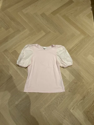 Ljusrosa topp med puffärmar S - Säljer denna jättesöta T-shirt ifrån hm i st S. Använd 1-2 gånger så är fint skick. Skriv om ni vill att jag ska visa de på💕
