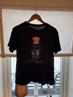 Ralph Lauren T-shirt  - Riktigt fet Ralph Lauren T-shirt utan några skavanker över huvudtaget. Trycket är helt felfri och tröjan är i storlek L men passar mer folk med storlek S till M björnen är dessutom i riktigt bra skick. Vid frågor om bilder eller liknande är det bara att fråga😄💛