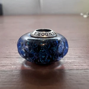 Berlock till Pandora armband - Blå muranoglas berlock i silver till Pandora armband. Så gott som nytt. Använt färre än 10 gånger. (Armband ingår ej i priset)
