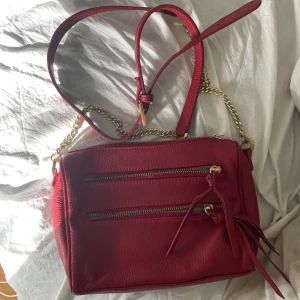 Röd axelremsväska  - Jättesöt liten väska med gulddetaljer! Justerbart band😇