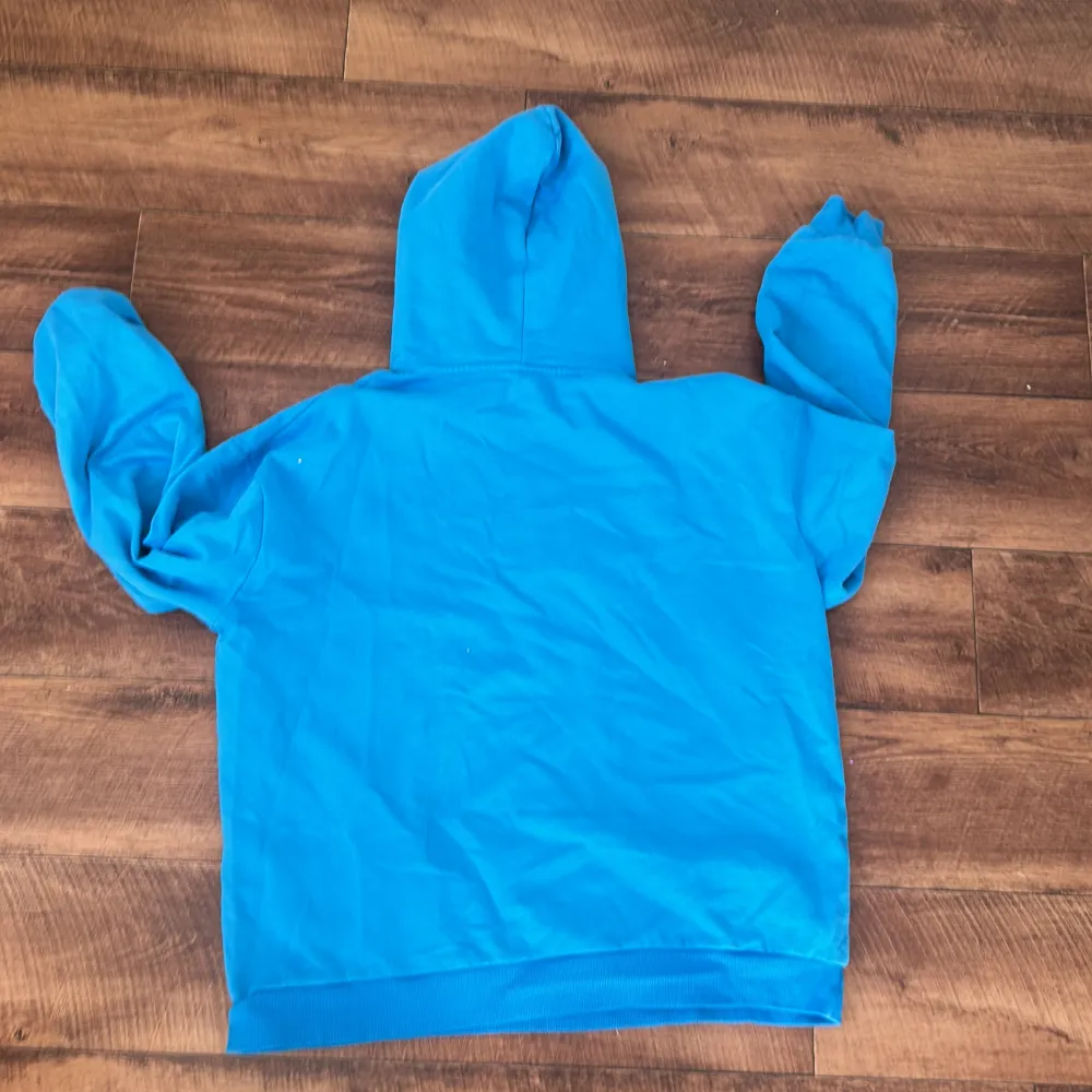 En blå hoodie som jag aldrig har använt, den har ingen framficka. Den är helt fel fri 💗. Hoodies.