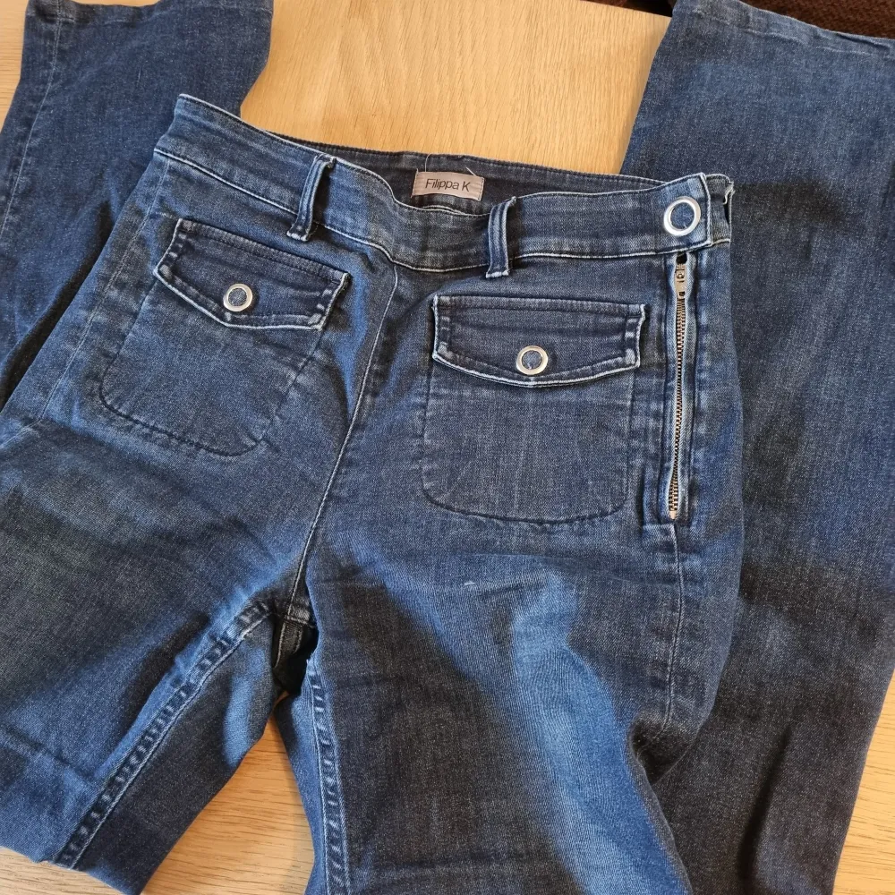 Högmidjade mörkblå jeans i lite rakare, bred modell. Ganska hög midja. Ser mindre ut på bilden men jag uppskattar att midjan passar allt från W26-W28 mkt stretch. Labeled as sz Small. Jeans & Byxor.