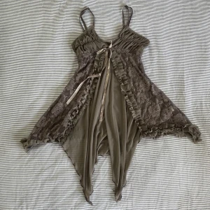 Grålila spets linne - Grålila räfflat meshlinne med blommor och rosetter. Mjukt och i fint skick. Axelband går att justera. Skriv gärna om du har fler frågor eller vill se ytterligare bilder!<3