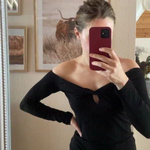 Off Shoulder topp - Svart top med tvistad detalj i bröstet. Använd nån enstaka gång, säljes då den inte används.