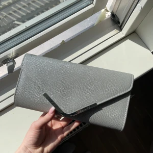 Balväska - Superfin väska till bal eller liknande, endast använd vid ett tillfälle så i väldigt gott skick. Tyvärr har färgen dock nöts bort lite i ett hörn, se bild. Nypris 379.