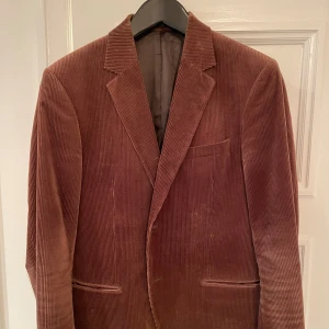 Brun manchesterkavaj från Tiger - Snygg manchesterkavaj från Tiger i gott skick. Säljes då den blivit för liten för mig.  Storlek 52.