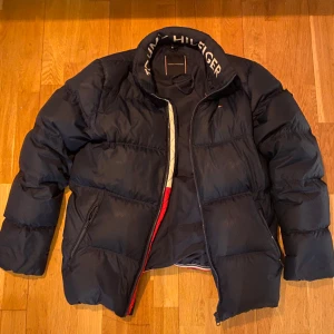 TOMMY HILFIGER JACKA - Tommy hilfiger jacka i god skick och perfekt till det kalla vädret. Inga defekter utan att luvan saknas. Nypris 2000kr. Skriv om pris diskutering eller intresse. 