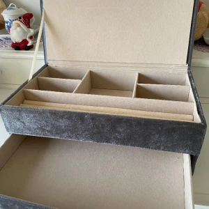 Smyckeskrin  - Ett grått smyckeskrin i sammet som har plats för massa olika smycken. Har inte haft den så länge för tyckte den var för liten för mig men är supersnygg. Funkar superbra att ha både ringer och halsband i men även armband och örhängen.