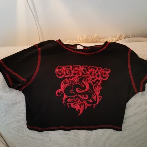 Black and red crop top with design - Cropped with design of snakes and text.