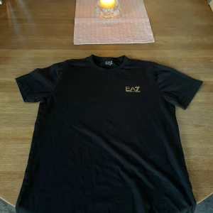 Armani/EA7 t shirt - Artikeln har använts sparsamt under flera år och är fortfarande i bra skick, men storleksetiketten är sliten. Måste köpas i bundle 
