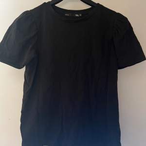 svart t-shirt med puffärm från lager157 i storlek xs, säljer då jag inte använder den. den är i fint skick, behöver bara strykas! skriv för fler bilder, köparen står för frakten