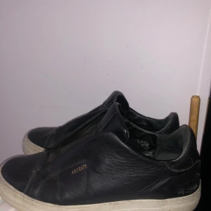 Svarta sneakers från Axel Arigato - Säljer ett par svarta sneakers från Axel Arigato. De är i skinn och har en vit sula. Skorna är i välanvänt skick men fortfarande snygga och bekväma. Perfekta för vardagsbruk! Tar gärna byten helst skor i storlek 43 och 43/5 😊