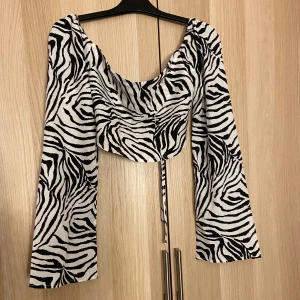 Zebra-mönstrad långärmad topp från SHEIN - Supersnygg och luftig långärmad topp i zebra-mönster. Tyvärr för stor för mig :(. Mycket fint skick, i princip inte använd. Öppen rygg som går att knyta. Storlek S men passar mer M, eventuellt L. 