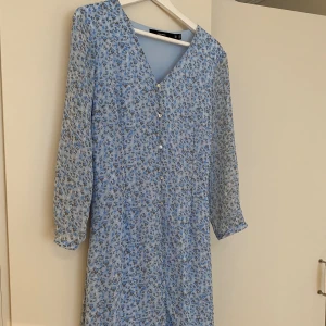 Blommig klänning  - Somrig klänning i skönt material. Strl L
