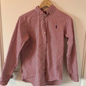 Ralph louren skjorta - Vit, röd skjorta i bra skick(inga hål, inga fläckar) Passar bra till speciella tillfällen men passar närsomhelst också såklart