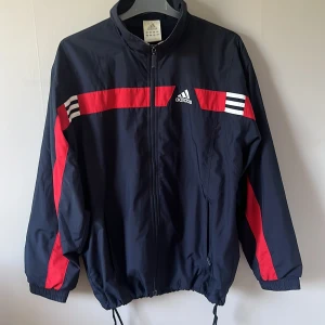 adidas jacka - vindjacka från adidas, köpt på secondhand men väldigt bra skick. man kan dra åt vid midjan men annars väldigt baggy. står ingen stolek men passar både S/M/L  