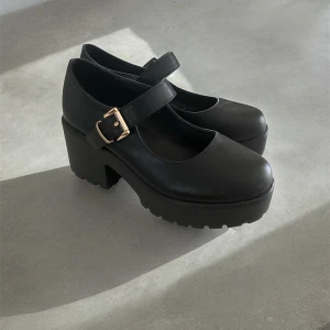 SVARTA MARY JANE, platåskor  - Klassiska Mary Jane! Nyskick! Endast provade,  tyvärr ej kommit till användning, därmed säljer jag. Så fortfarande oanvända! Förstklassig skinnimitation, 7,5cm blockklack. Köpta på Zalando, nypris 529kr!