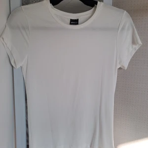 Vit t-shirt - En enkel och stilren vit t-shirt från Gina Tricot med korta ärmar och rund halsringning. Perfekt för vardagsbruk, väldigt skön.💓 I nyskick, aldrig använd✨️  Skriv om du har frågor!💗