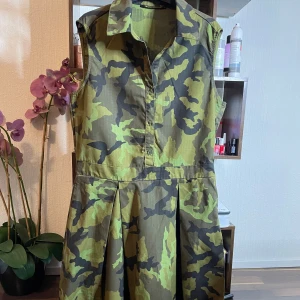 Grön Klänning med mönster på  - Fick denna klänningen ett par månader sedan när jag fyllde år men för liten tyvärr annars super snygg stilig klänning ifrån ett unikt märkte som inte finns i Sverige skön material mellan kort klänning 