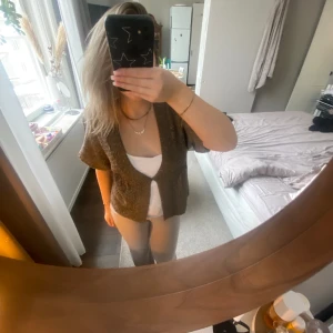 Stickad kofta med en knapp - Jätte fin unik grov stickad kofta med en knapp, färgen är brun/beige/grå med guldiga detaljer. Använt fåtal gånger. Hör av er vid ev frågor💕