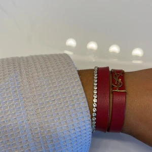 YSL armband  - Säljer mitt superfina YSL armband i en jättefin mörkröd färg, kommer tyvärr inte till användning längre! Nypris 3600! 