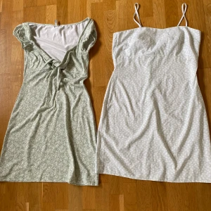 Två sommarklänningar  - Två ljusgröna sommarklänningar med vita blommor i fint skick