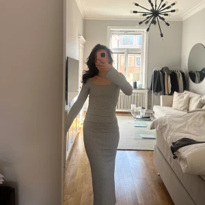 Grå långklänning från Nelly - Långklänning från Nelly i storlek XS, vida armar och stickad/ribbad i materialet. Endast använd en gång🤍