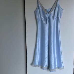 Ljusblå sidenklänning (100% siden). Strl S (från Axel till fåll är den 91 cm). Mycket god kvalitet.
