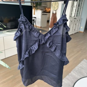 Svart linne med volanger  - Super fint svart linne med volanger. Mycket bra skick. Gammal modell som inte säljs längre. Köparen står för frakten🫶🫶