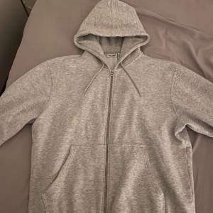 En grå zip up hoodie från weekday. Den är knappt använd och gott som ny. 