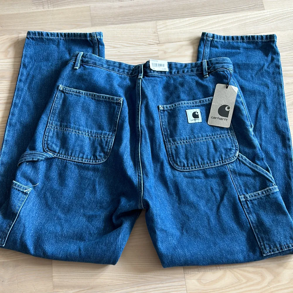 Jag säljer ett par helt nya blå carhartt jeans då de är för stora för mig. De är i RW/ Boyfrend modell W31 L00. . Jeans & Byxor.
