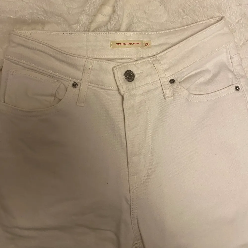 Säljer ett par vita tajta jeans från Levis. De är i storlek 26 och är i bra skick, hittade dock en liten fläck på smalbenet som syns på sista bilden. . Jeans & Byxor.