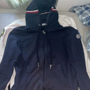 Moncler maglia - Säljer den här för att ja håller på rensa min garderob. Väldigt snygg zip hoodie. Säljer den billigt för att jag har råkat blekt den på magen. Priset är inte hugget i sten. Hör av er om ni ha några fråger.