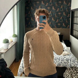 Ralph Lauren Tröja  - Säljer denna kabelstickade ralphlauren tröja som är i ett väldigt bra skick, inga defekter. Storlek M - true to size Modell 187cm 83kg 