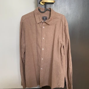 Brun linneskjorta - Brun skjorta från HM, använd fåtal gånger. Storlek M, sitter som större M. Nypris 400, finns i Sollentuna.