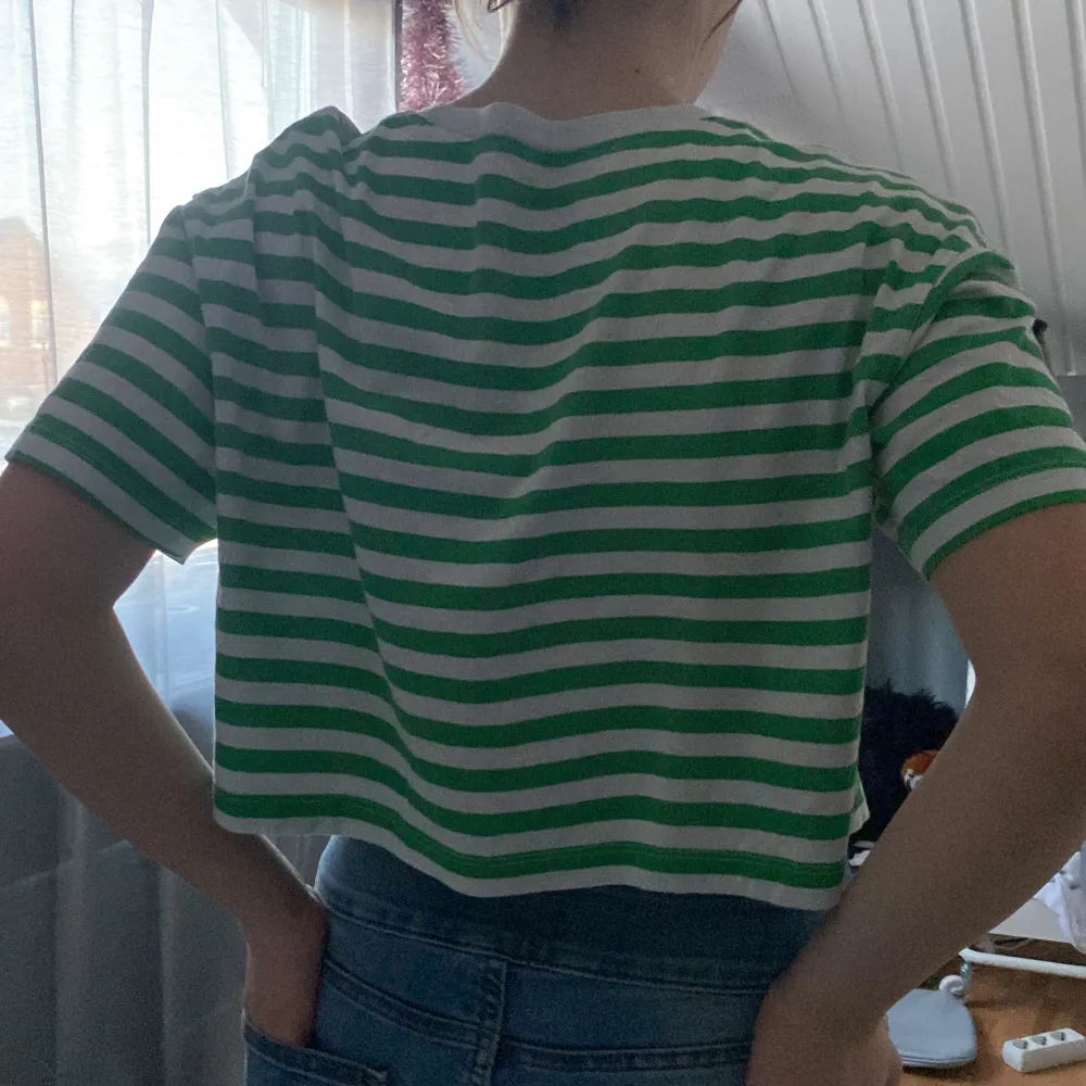 A green and white striped t shirt, short, only used a few times, good condition . T-shirts.