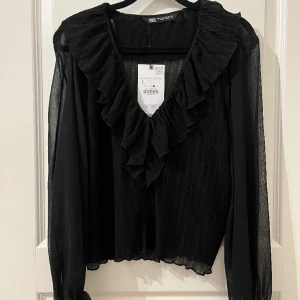 Zara blus - Svart Zara blus med volang ,aldrig använt.