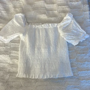 Gullig vit topp - Jättesöt vit topp. Vet inte riktigt vart den är ifrån tyvärr. Priset kan diskuteras. Använd ett fåtal gånger endast. Går att ha på olika sätt. Jättefin till sommaren till exempel.