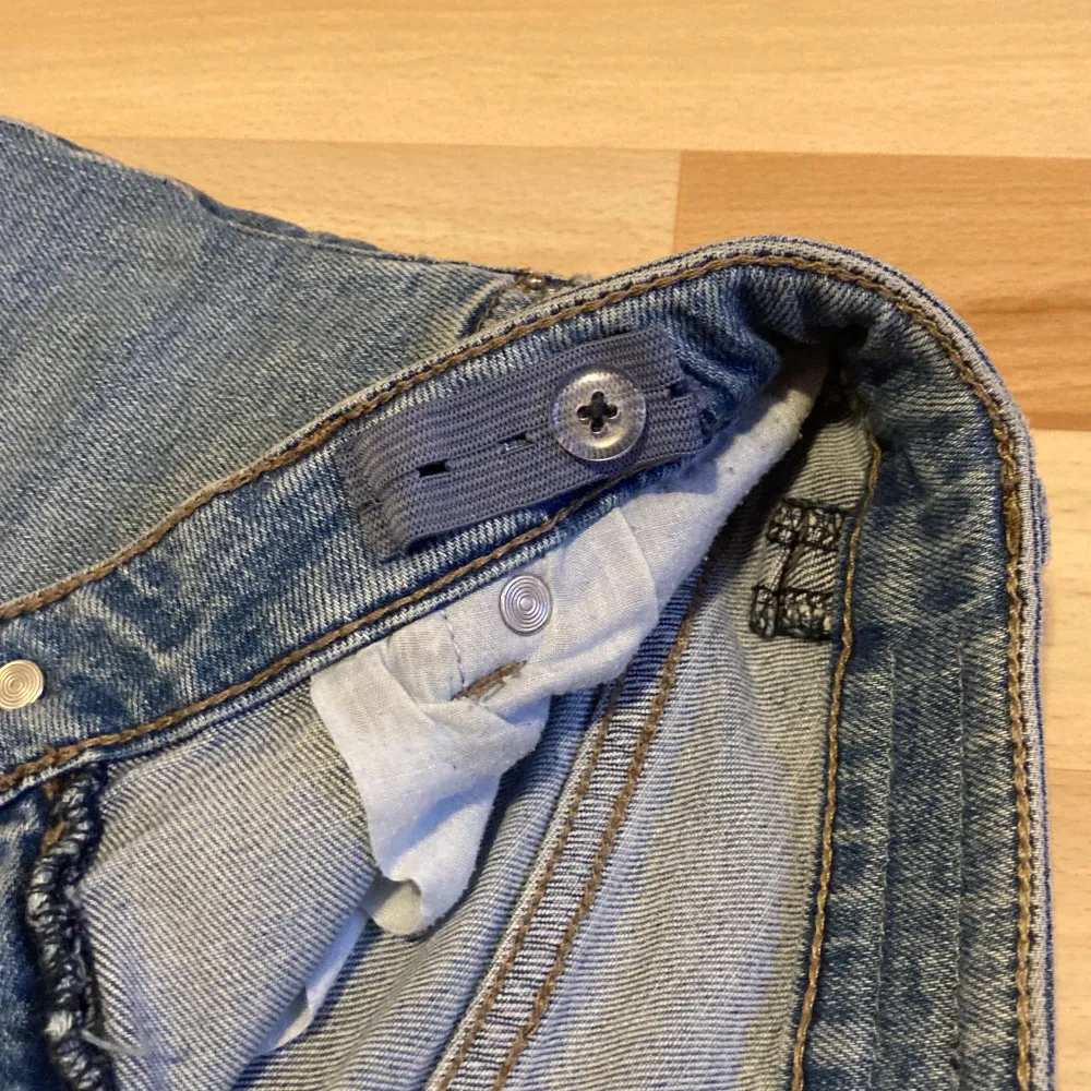 Blå jeans från LAB Industries med hål på knäna och en justerbar midja. Tecken av användning kan synas på bakfickorna, men inget som syns tydligt.💕💕💕. Farkut & Housut.