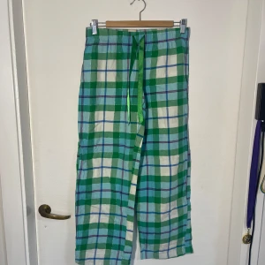Gröna rutiga pyjamasbyxor från Xhilaration - Säljer ett par bekväma gröna rutiga pyjamasbyxor från Xhilaration. Byxorna har en elastisk midja med snörning för extra komfort. Perfekta för en avslappnad dag hemma.
