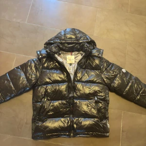 Moncler Jacka Maya - Jackan är storlek L men kan även passa på M. Den är i helt nytt skick har aldrig använts och har inga märken eller liknande på sig.