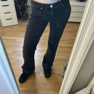 Svarta lågmidajde  bootcut jeans - Passar mig som är 172, skulle säga att dem är små i storleken då dem passar mig som vanligtvis har S men skulle säga att dem även passar M. (Dem är i storlek 42). Dem är uppsprättade nere som syns på bilden.