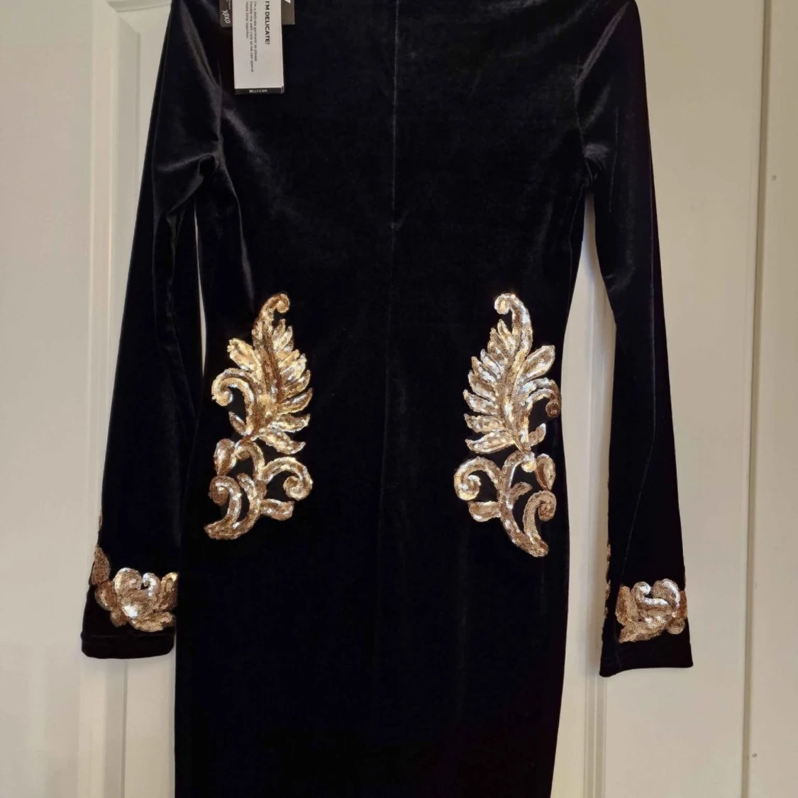 Svart sammetsklänning med guldiga broderier
